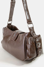 Brown leather handbag with a shoulder strap on a white background