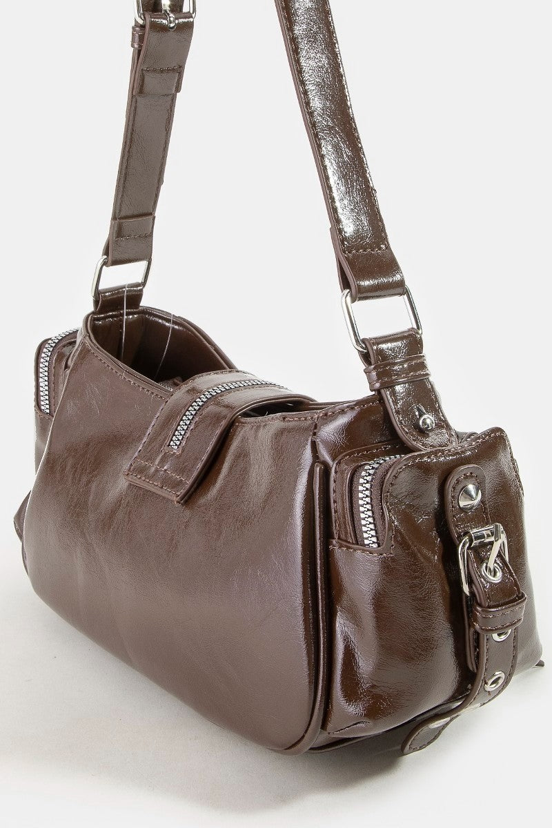 Brown leather handbag with a shoulder strap on a white background