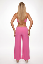 Person wearing a pink outfit on a white background
