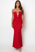 Woman wearing a red strapless dress against a white background