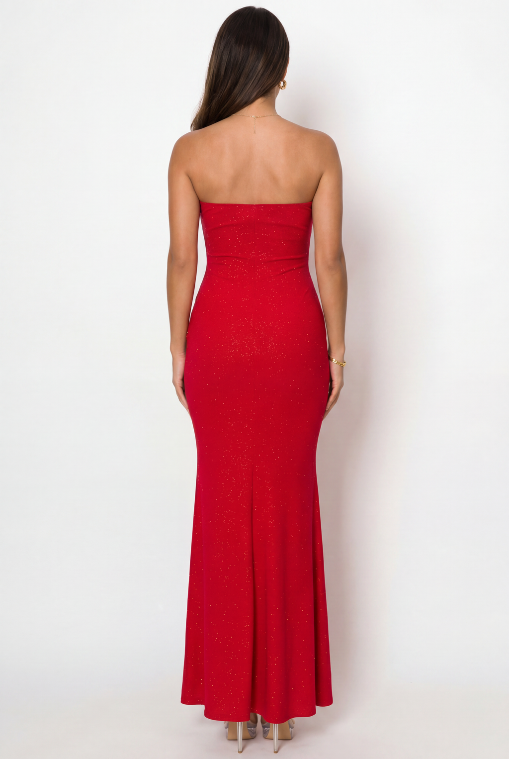 Woman wearing a strapless red dress against a white background