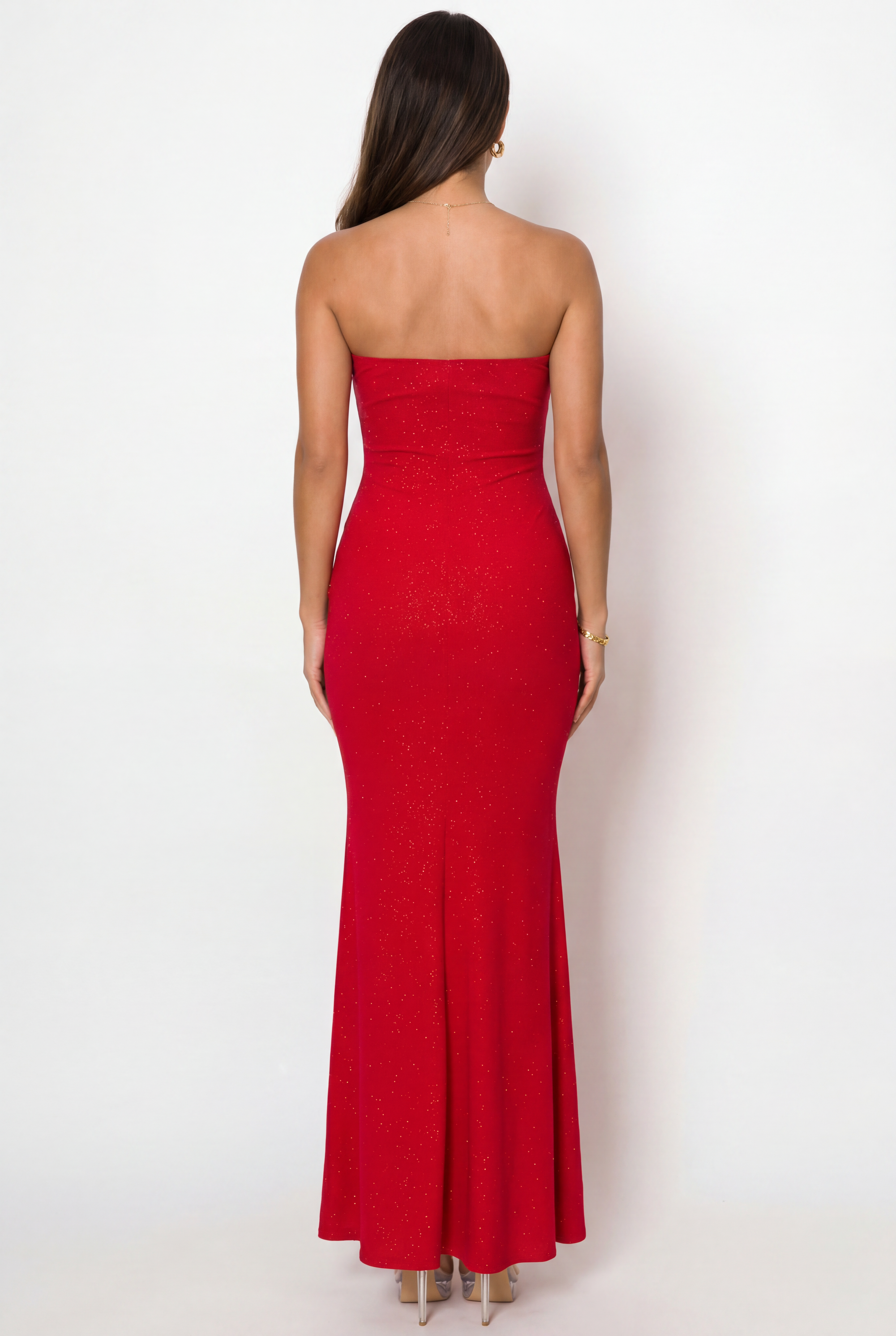 Woman wearing a strapless red dress against a white background