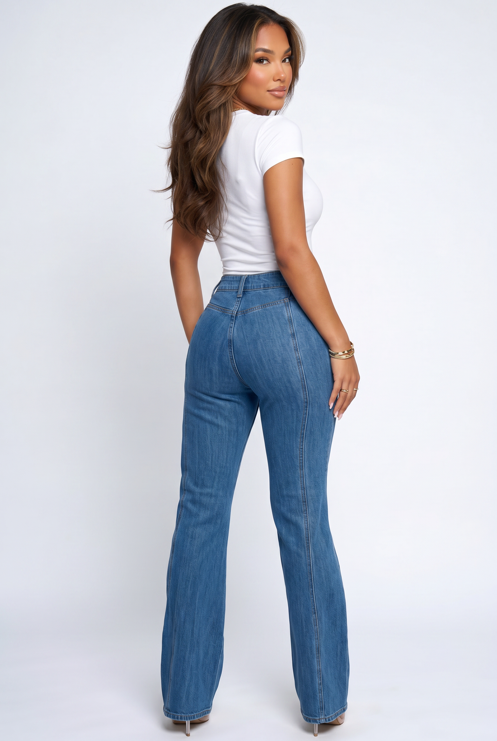 Woman wearing blue jeans and a white top on a white background