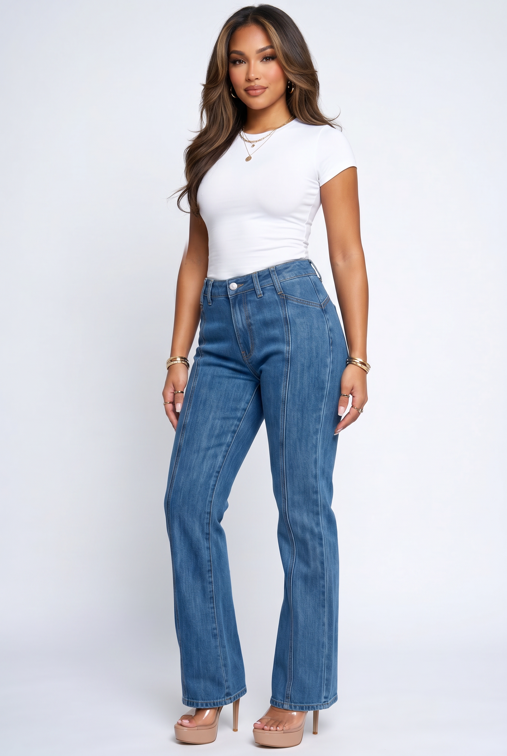 Woman wearing a white top and blue jeans on a white background