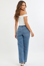 Woman modeling blue polka dot pants in various poses on a white background
