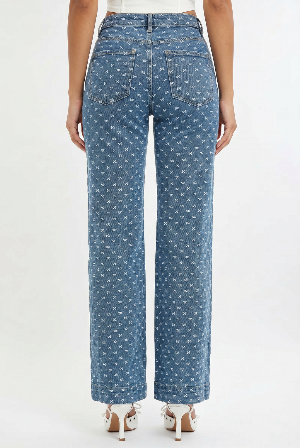 Blue patterned jeans worn by a person on a white background