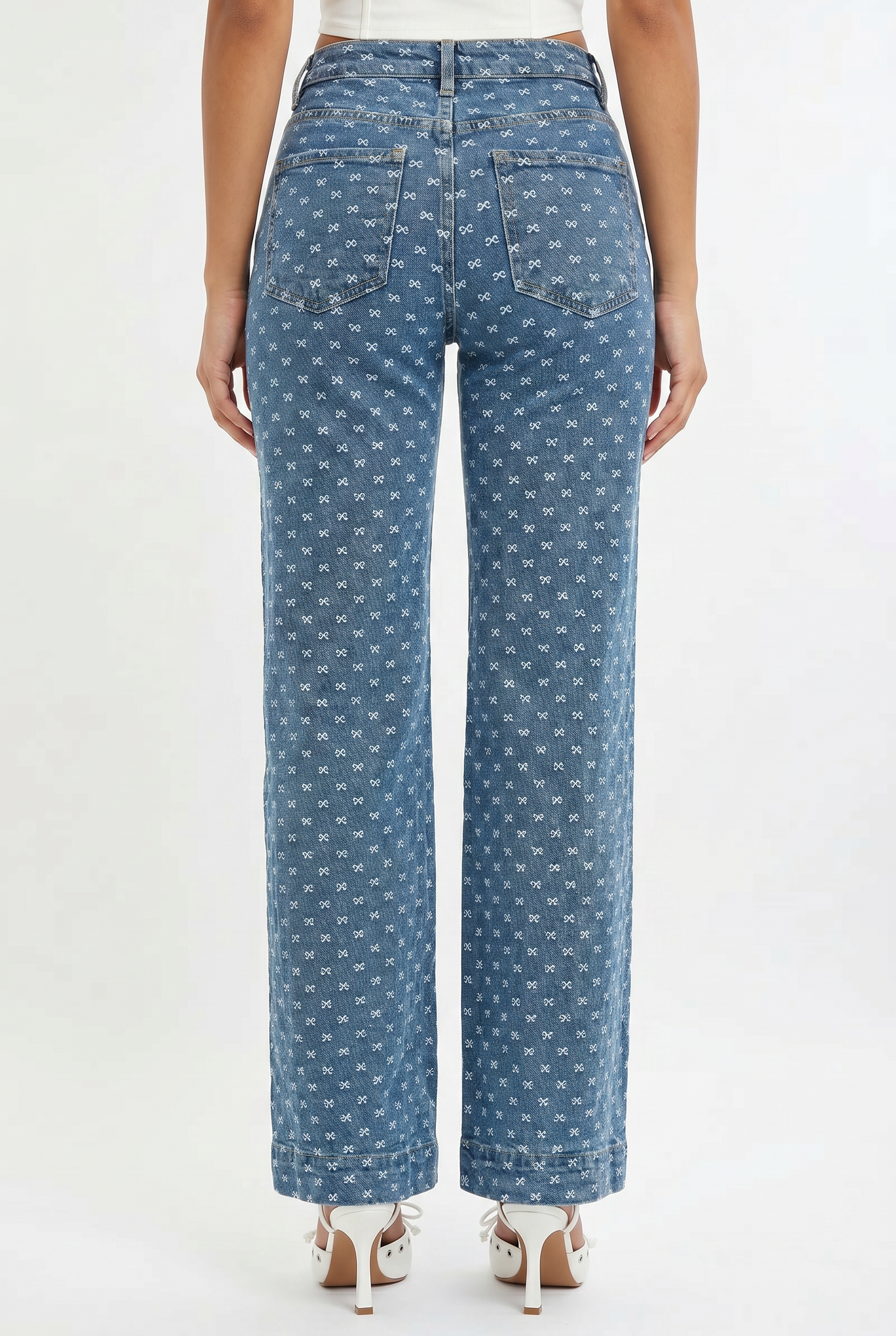 Blue patterned jeans worn by a person on a white background