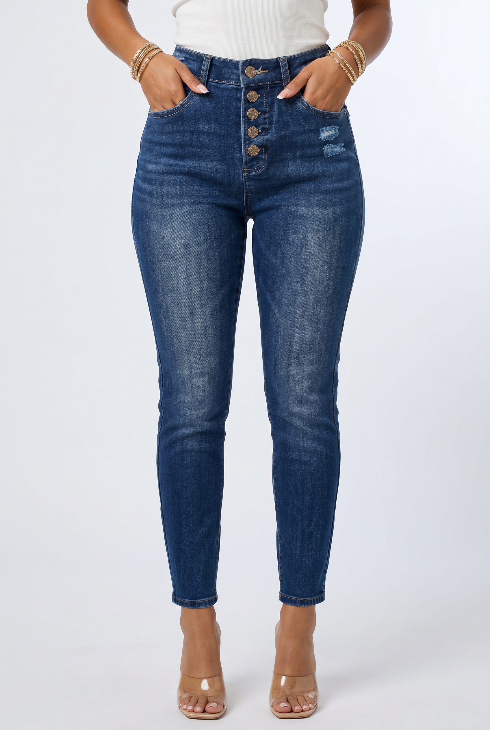 Person wearing blue jeans on a white background