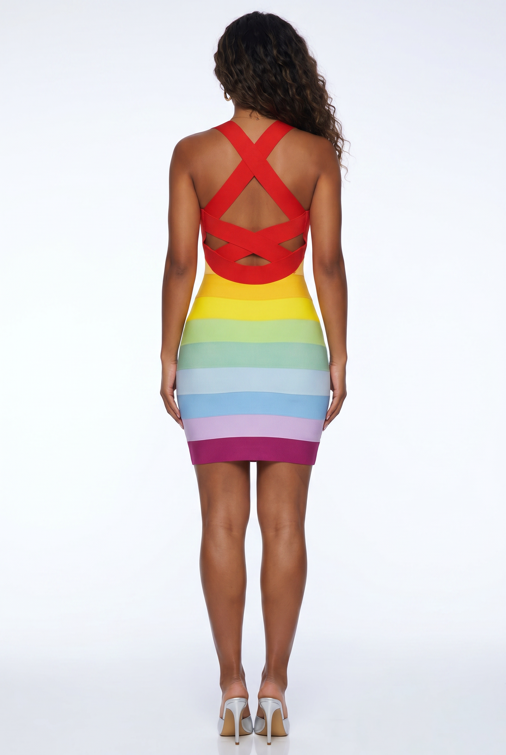Woman wearing a colorful dress with a red backless top and multicolored skirt on a white background