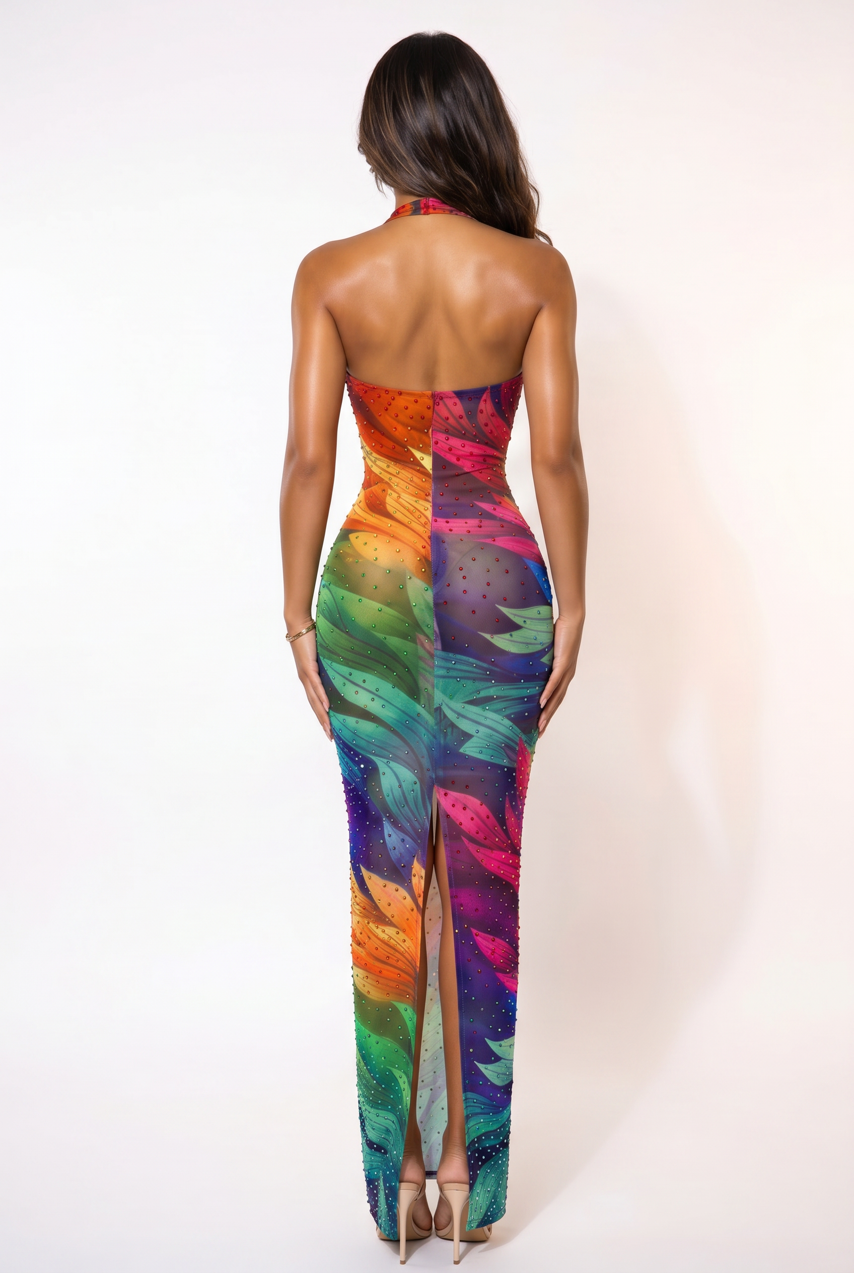 Woman wearing a colorful strapless dress with a high slit on a white background