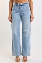 Light blue jeans worn by a person on a white background