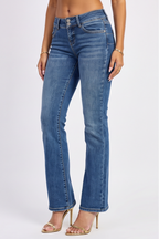 Woman modeling an orange top and blue jeans from different angles on a white background