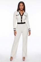 White outfit with black accents worn by a model on a white background