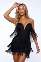 Black fringe dress worn by a model on a white background