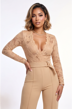 Beige lace jumpsuit worn by a model on a white background
