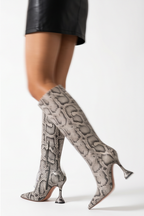 Four views of snake print grey knee-high boots on a white background